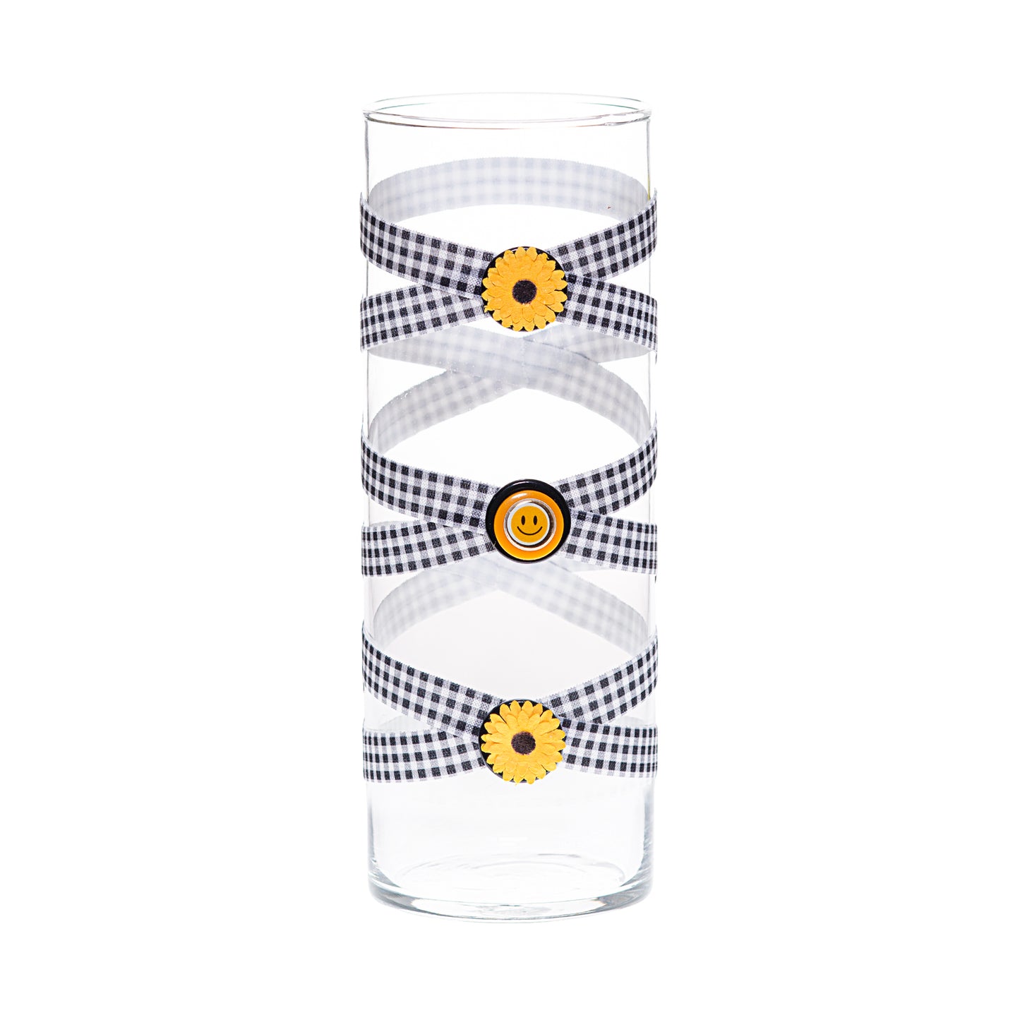 Front of Glass Wrappings 10" glass bud vase wrapped in black & white check elastic, decorated with 3 small sunflowers and a gold smiley face.