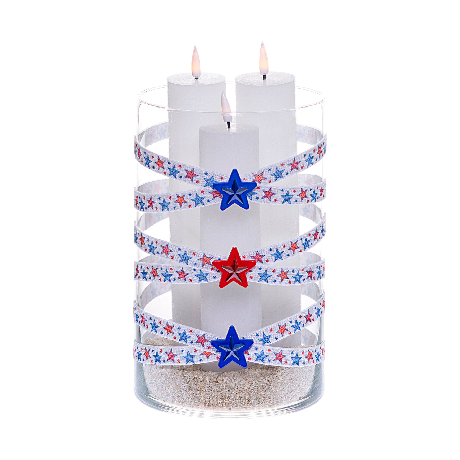 Front of Glass Wrappings 6" x 10" cylinder wrapped in white elastic with red and blue stars, adorned with red and blue gem stars on 1-1/2" red and blue star buttons. It is filled with 3 white candles.