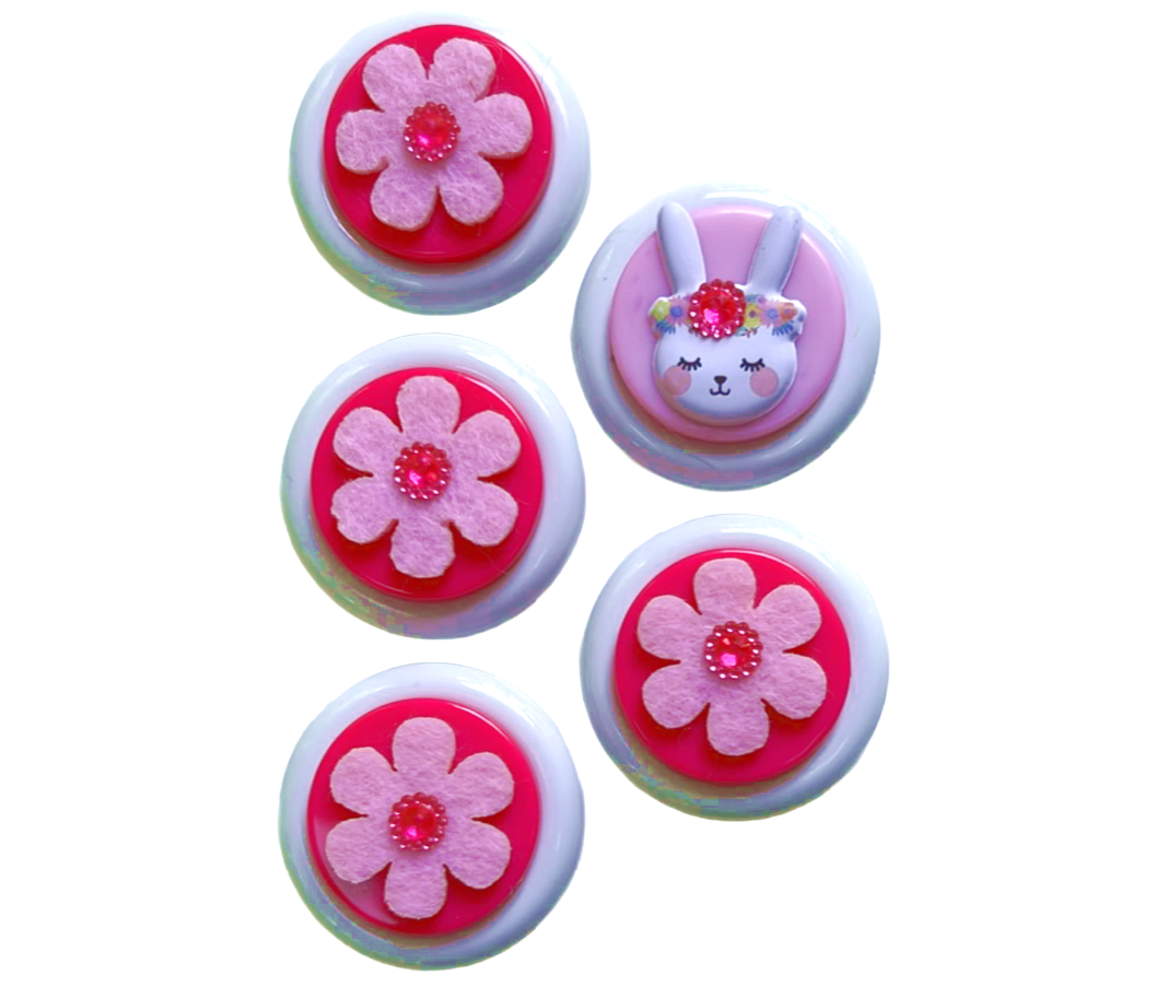 Glass Wrappings set of 5 spring embellishments.  4 pink flowers and 1 jeweled bunny sit atop white buttons.