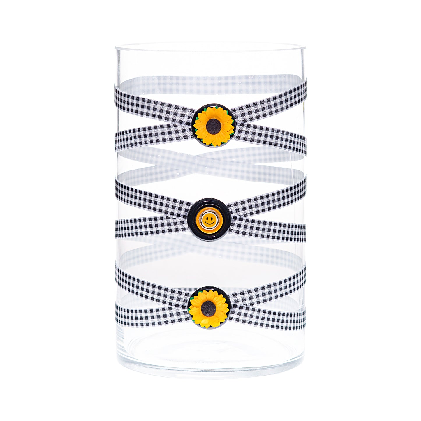Front of Glass Wrappings 6" x 10" cylinder wrapped in black and white check elastic, decorated with  sunflowers and a yellow smiley face.