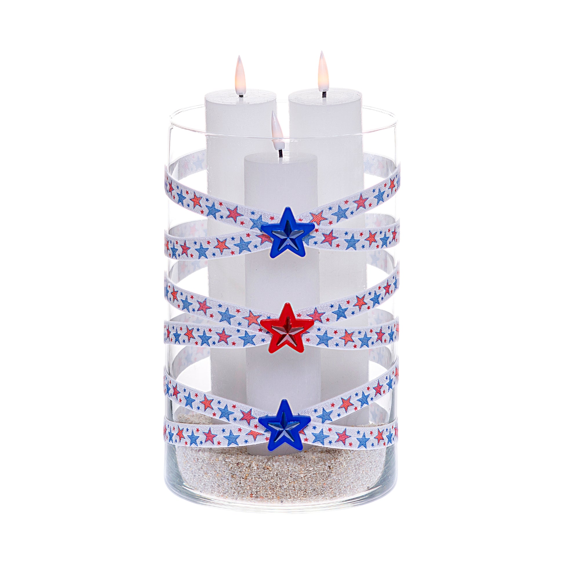 Front of Glass Wrappings 6" x 10" cylinder wrapped in white elastic with red and blue stars, adorned with red and blue gem stars on 1-1/2" red and blue star buttons.  It is filled with 3 white candles.